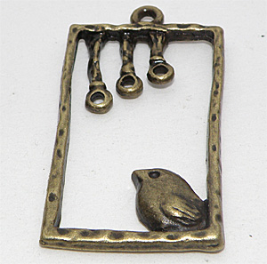 Bronsfärgad berlock fågel i ram 35×19 mm